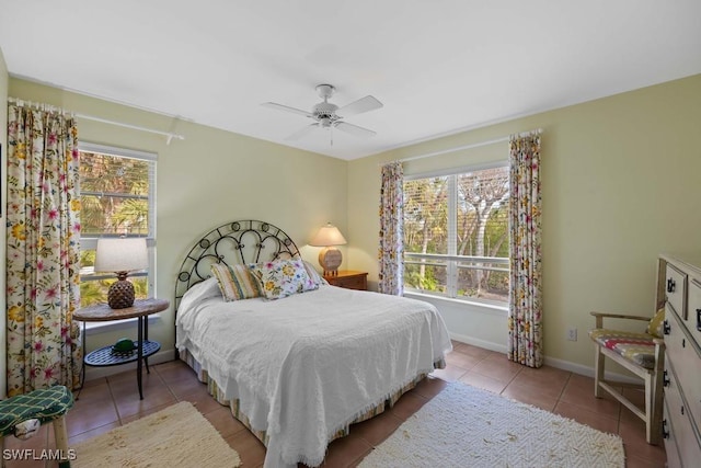 tiled bedroom featuring ceiling fan