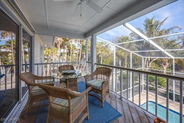 sunroom / solarium featuring ceiling fan