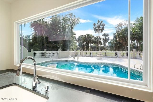 view of swimming pool with sink