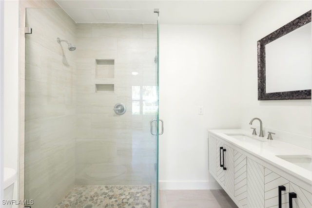 bathroom with vanity and a shower with door