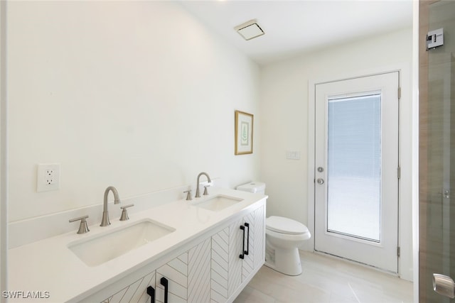 bathroom featuring tile patterned flooring, vanity, and toilet