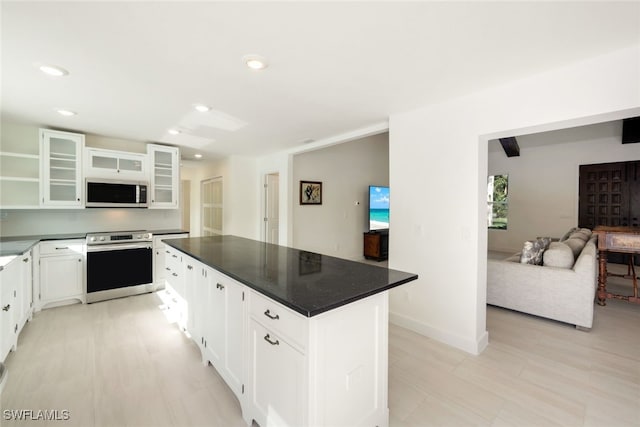 kitchen with a kitchen island, white cabinetry, and stainless steel appliances