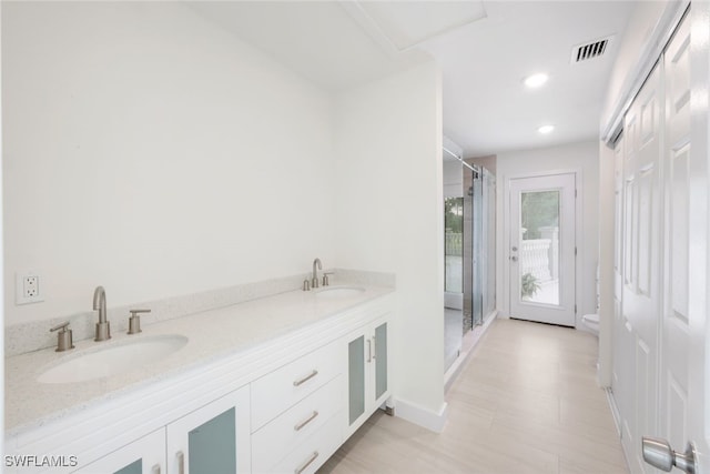 bathroom with vanity, toilet, and walk in shower