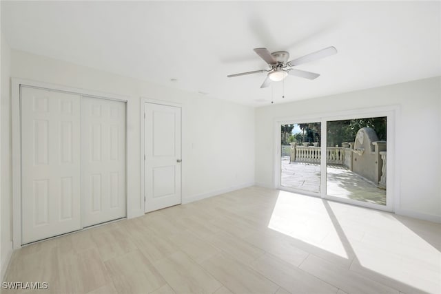 unfurnished bedroom with ceiling fan and access to exterior