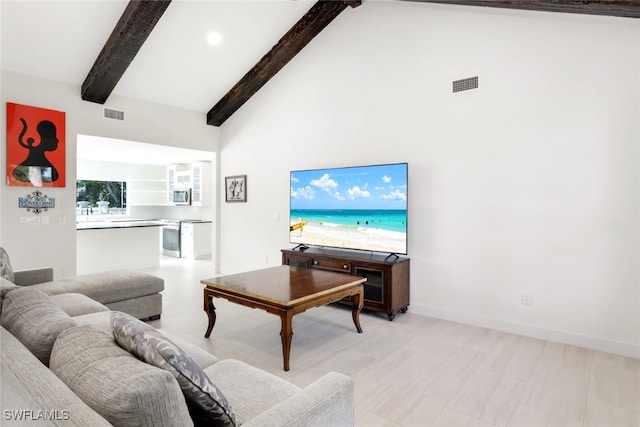 living room with beam ceiling and high vaulted ceiling