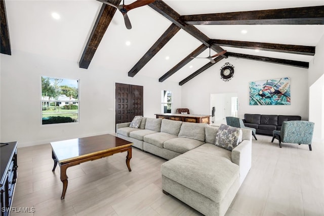 living room with beam ceiling, ceiling fan, and high vaulted ceiling