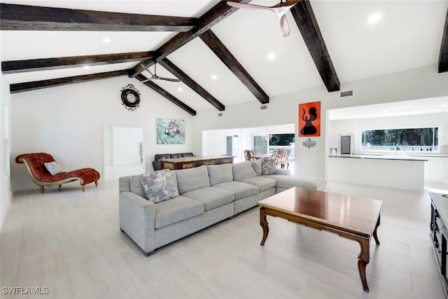 living room with beamed ceiling, ceiling fan, and high vaulted ceiling