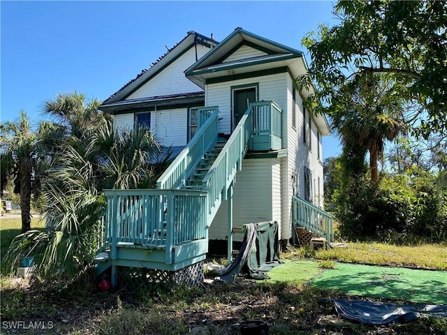 rear view of house with a wooden deck