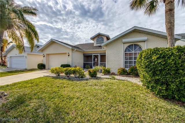 view of front of house featuring a garage and a front lawn