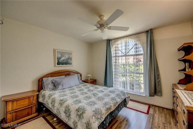 bedroom with hardwood / wood-style floors and ceiling fan