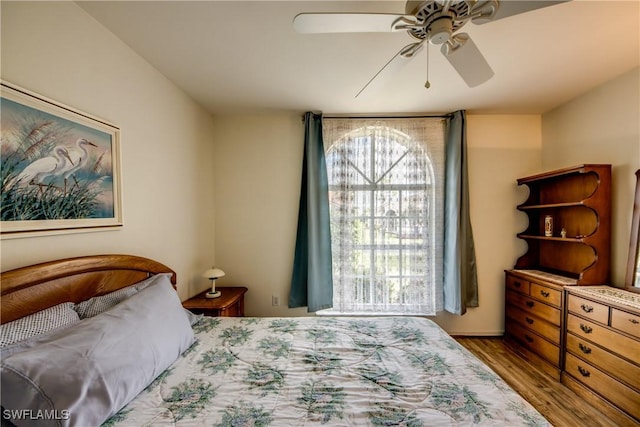 bedroom with ceiling fan and light hardwood / wood-style floors