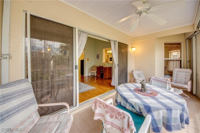 sunroom featuring ceiling fan