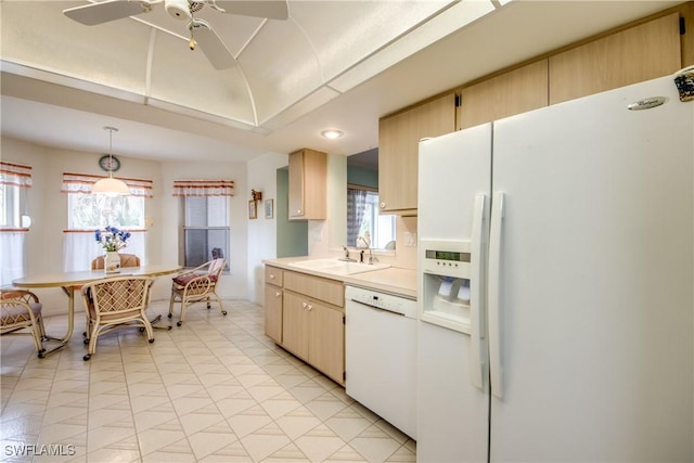 kitchen featuring light brown cabinetry, white appliances, ceiling fan, sink, and decorative light fixtures