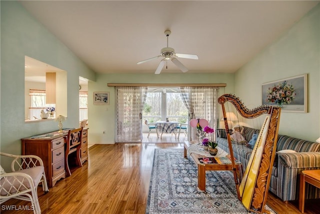 living room featuring vaulted ceiling, plenty of natural light, and ceiling fan