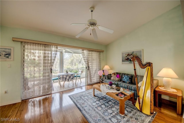 living room featuring ceiling fan, vaulted ceiling, and hardwood / wood-style flooring