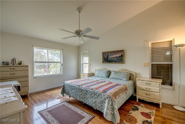 bedroom with hardwood / wood-style floors, ceiling fan, and lofted ceiling