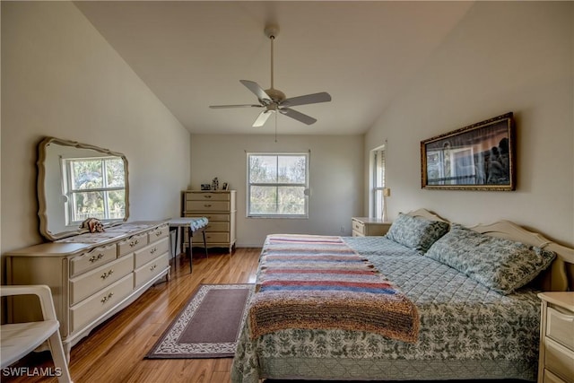 bedroom featuring multiple windows, light hardwood / wood-style flooring, and ceiling fan