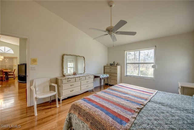 bedroom featuring light hardwood / wood-style floors, vaulted ceiling, and ceiling fan