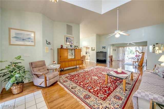 living room featuring wood-type flooring, ceiling fan, and lofted ceiling