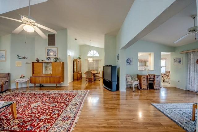 living room featuring ceiling fan, light hardwood / wood-style floors, and lofted ceiling