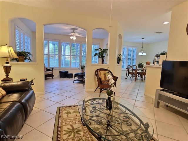 tiled living room with ceiling fan