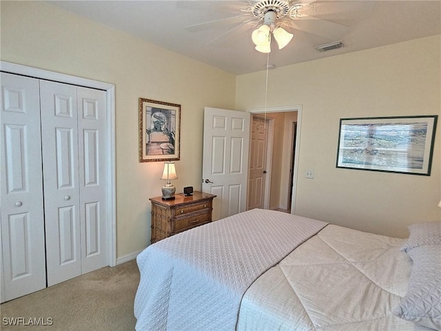 carpeted bedroom with a closet and ceiling fan