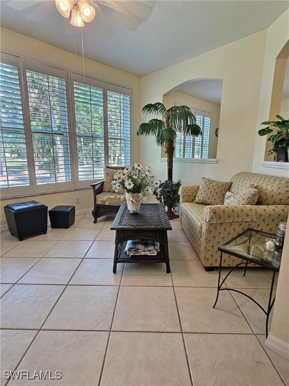 tiled living room with ceiling fan