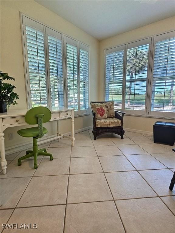 living area featuring a wealth of natural light and light tile patterned floors