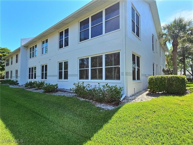 view of property exterior with a lawn