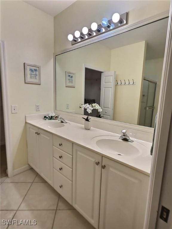 bathroom with vanity, an enclosed shower, and tile patterned flooring