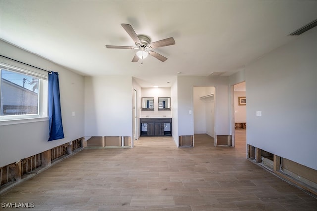 unfurnished living room with hardwood / wood-style flooring and ceiling fan