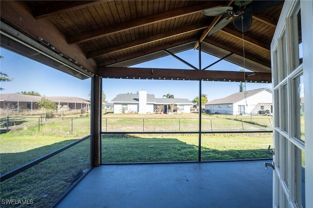 unfurnished sunroom featuring lofted ceiling with beams, wood ceiling, and ceiling fan