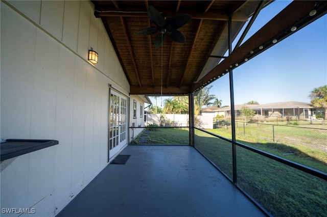 unfurnished sunroom featuring ceiling fan