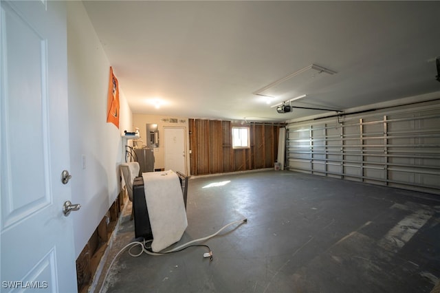 garage with a garage door opener and electric panel