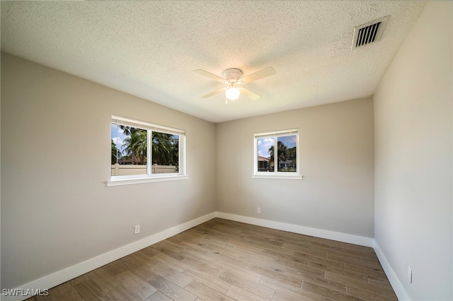 6080 Park Rd, Fort Myers, FL 33908 - unfurnished room featuring ceiling fan, baseboards, wood finished floors, and a textured ceiling
