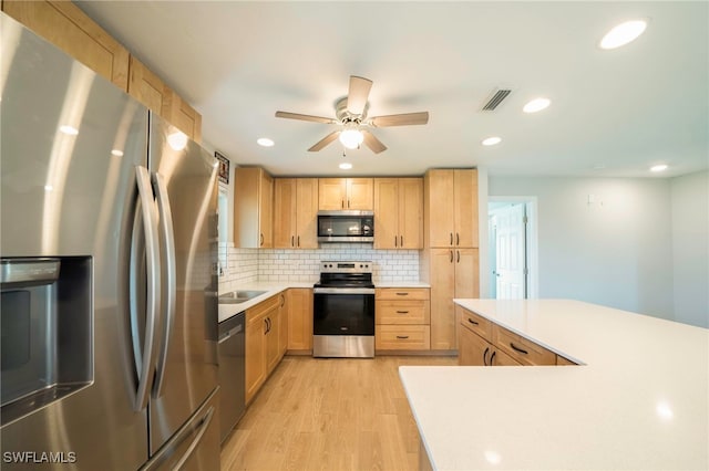 6080 Park Rd, Fort Myers, FL 33908 - kitchen featuring stainless steel appliances, light brown cabinetry, ceiling fan, light wood-style flooring, and recessed lighting