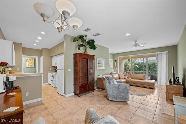 living room with ceiling fan with notable chandelier and light tile patterned flooring