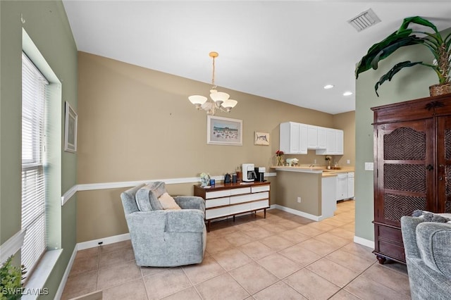 sitting room with a notable chandelier and light tile patterned floors