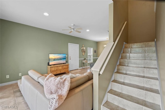 staircase featuring tile patterned floors and ceiling fan