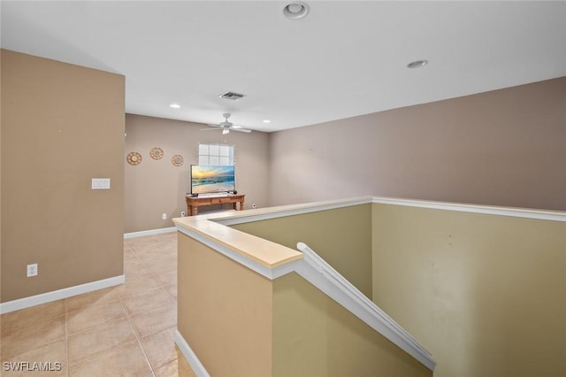 hall with light tile patterned floors