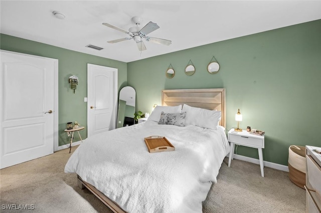 bedroom featuring ceiling fan and light carpet