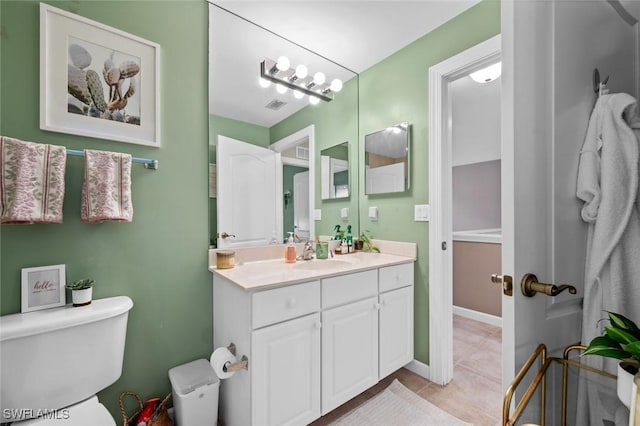 bathroom with tile patterned floors, vanity, and toilet