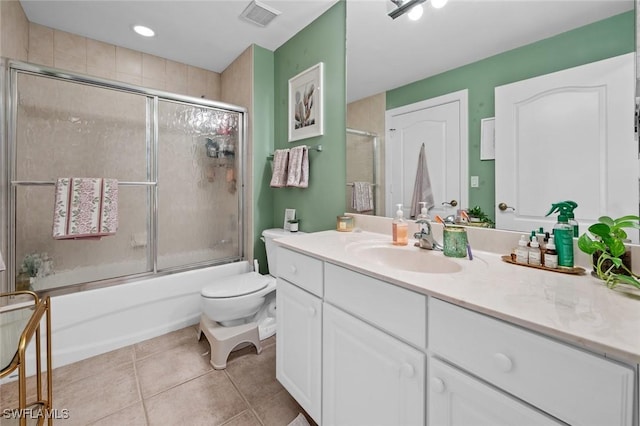 full bathroom with tile patterned flooring, vanity, toilet, and combined bath / shower with glass door