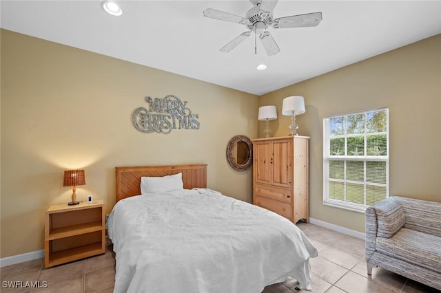 bedroom with ceiling fan and light tile patterned floors