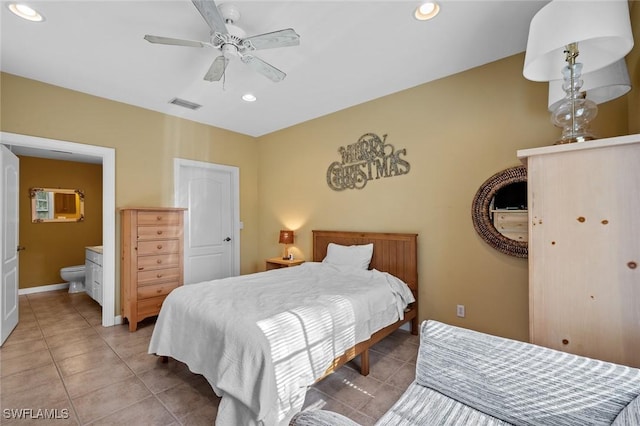 tiled bedroom featuring ensuite bath and ceiling fan