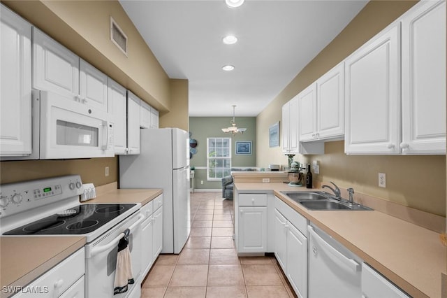 kitchen featuring white cabinetry, sink, hanging light fixtures, and white appliances