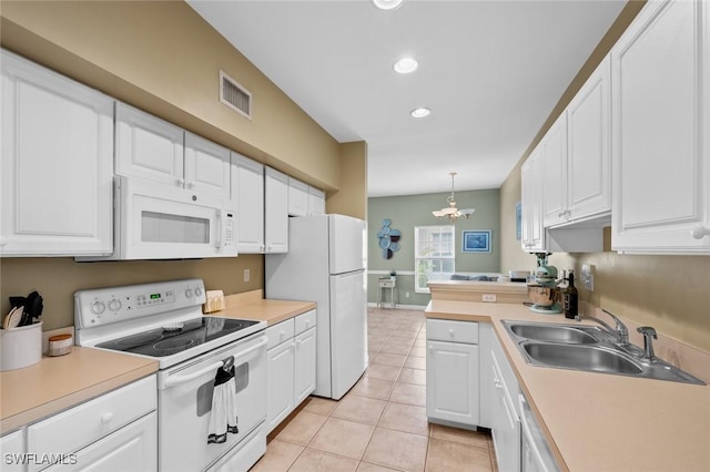 kitchen with white cabinets, white appliances, decorative light fixtures, and an inviting chandelier