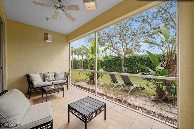 sunroom / solarium featuring ceiling fan