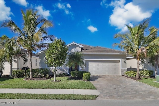 view of front of home with a front lawn and a garage