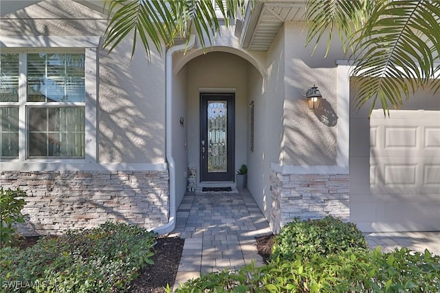 view of exterior entry with a garage